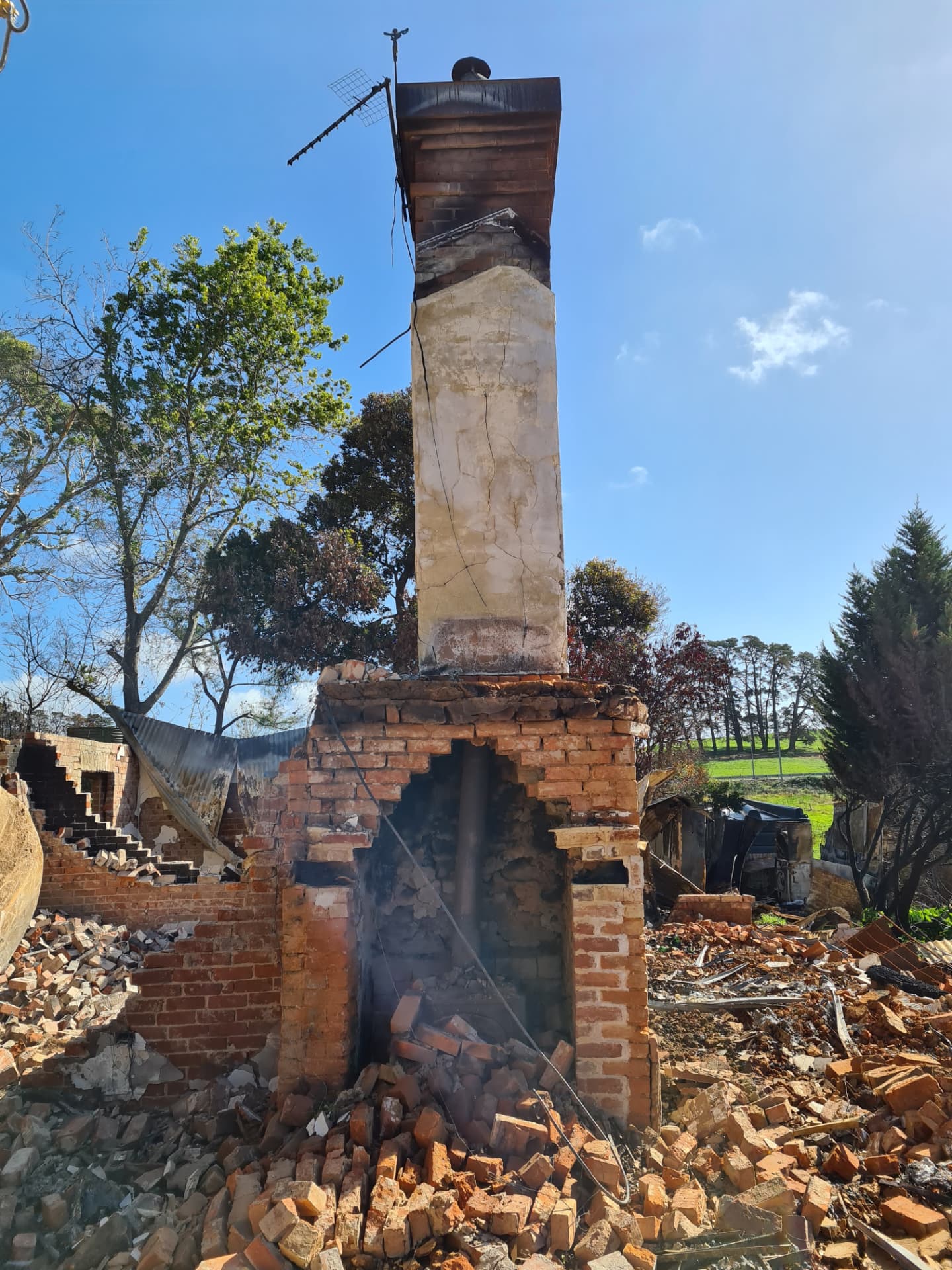 A brick chimney left standing above the rubble of a house destroyed in the Adelaide Hills bushfires